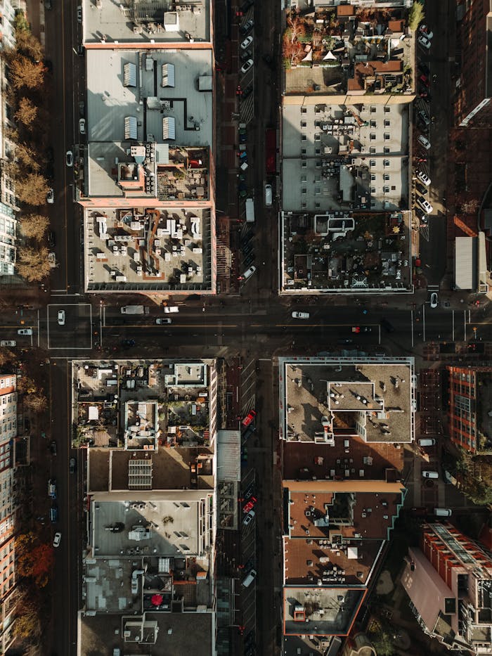 Top-down aerial view of an urban intersection in downtown Vancouver, BC, showcasing city architecture.